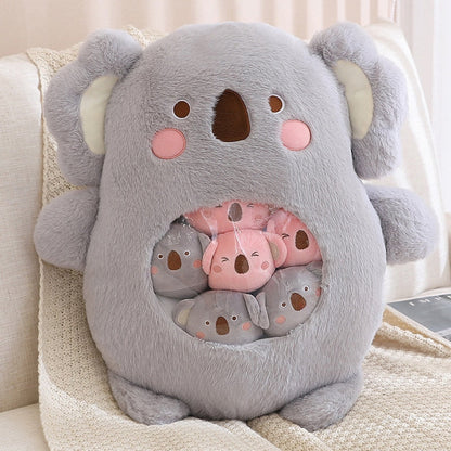 Plush animal shaped pillow in light grey, close-up koala face with embroidered paw circle