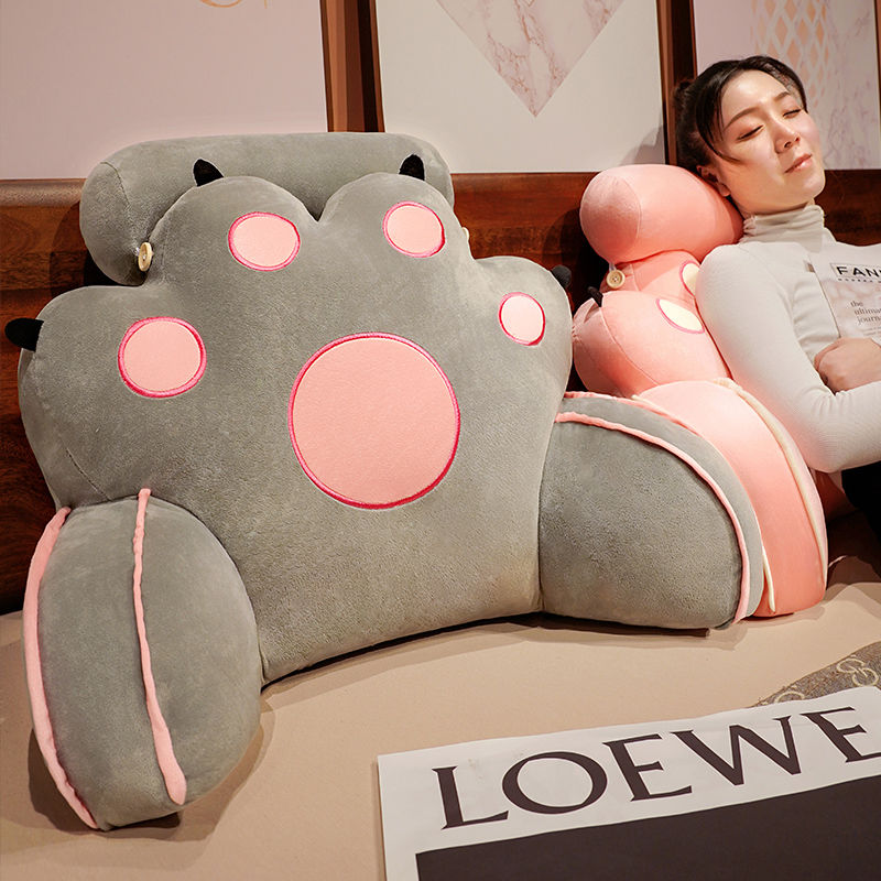 Gray cat-paw reading pillow with rounded paws and pink outlined face details
