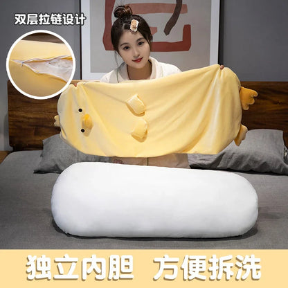 Long yellow chick plush pillow with rounded shape and stitched face, laid horizontally