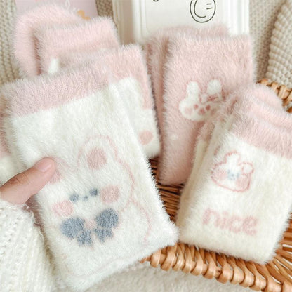 Bunny socks set in white with pastel paw prints and bunny motifs, fuzzy soft fabric.