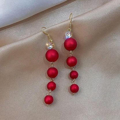 Red beaded ornament drop earrings with gold-tone hooks and faceted crystals