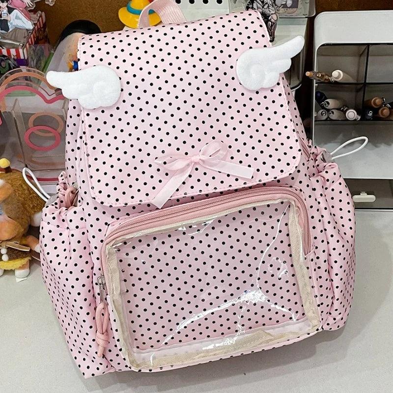 Pink polka dot backpack with transparent front pocket, bow, and plush cloud appliques