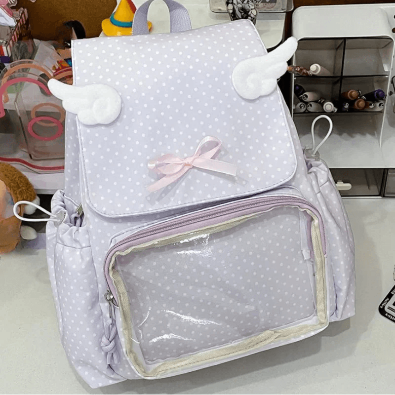 Light purple polka dot backpack with transparent pocket, bow, and plush cloud details