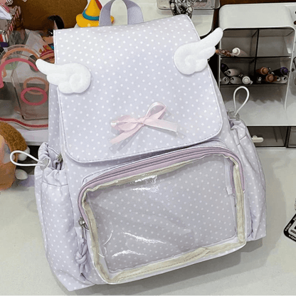Light purple polka dot backpack with transparent pocket, bow, and plush cloud details