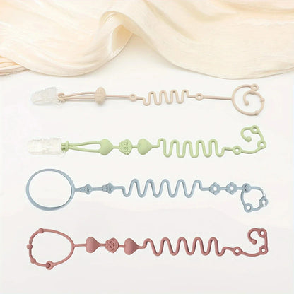 Flat lay of four silicone pacifier chain toys in pastel beige, green, blue, and pink