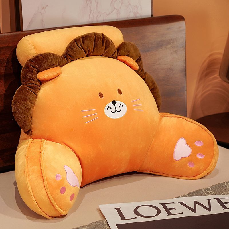 Orange plush reading pillow with brown animal-face design and cute facial features