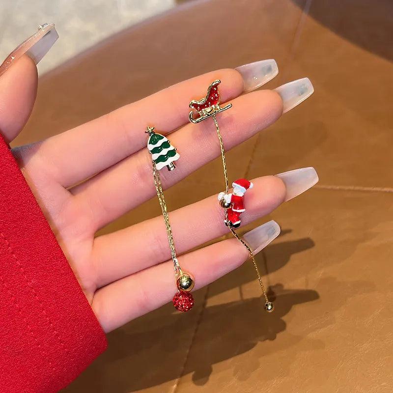 Gold-tone holiday drop earrings with tree and Santa charms, red berry and bead details