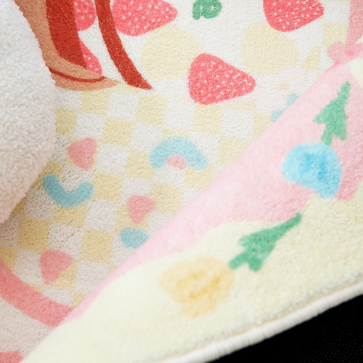 Pastel plush area rug corner with checkered hearts and strawberry motifs