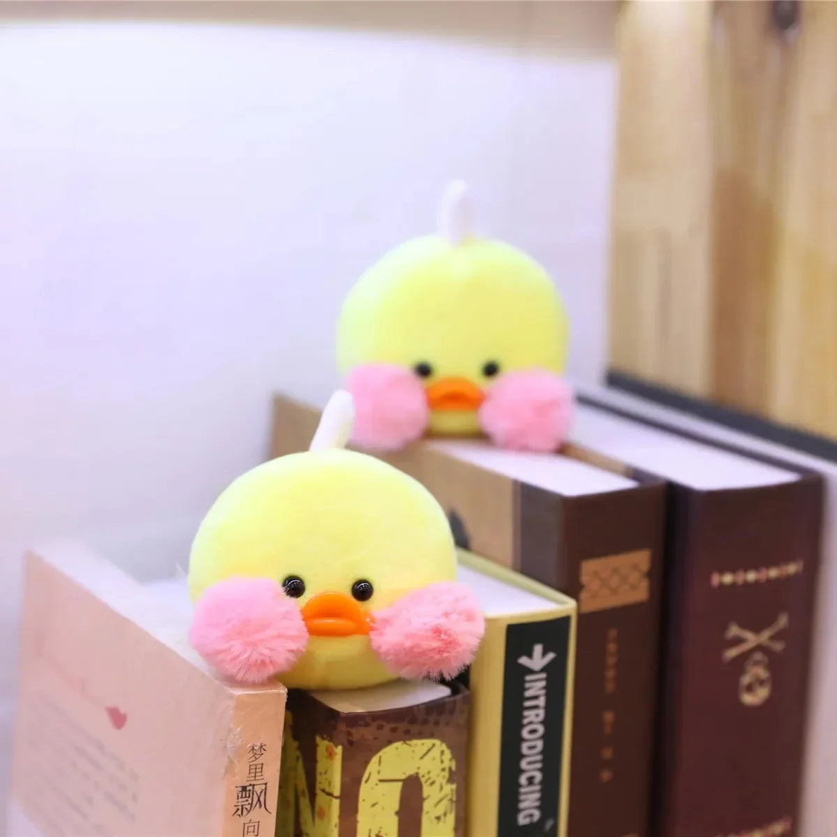 Yellow duck plush with pink paws and orange beak