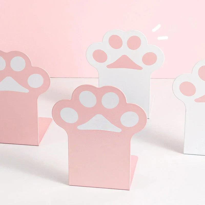 Three cat paw bookends with pink bases and white paw emblems, desk organizer