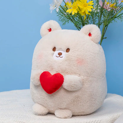 Cream bear plush with red heart on its chest, sitting against a blue backdrop.