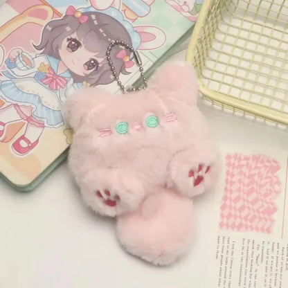 Pink cat plush keychain with mint buttons, paw prints, and metal chain