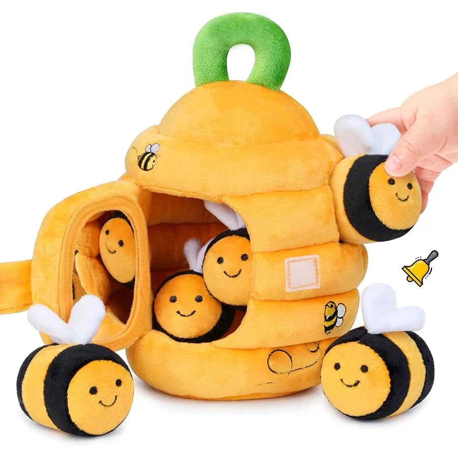 Soft yellow beehive sensory toy with smiling bee faces, dangling plush wings, and handle loop