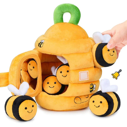 Soft yellow beehive sensory toy with smiling bee faces, dangling plush wings, and handle loop