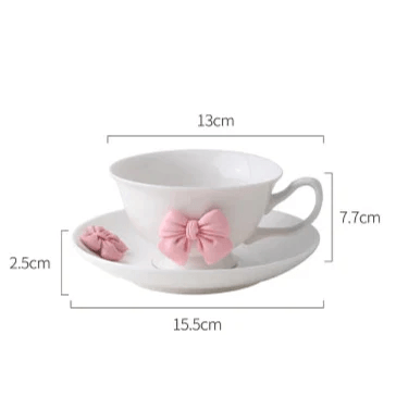 Tea cup and saucer dimensions diagram: white cup with pink bow, 13cm by 15.5cm