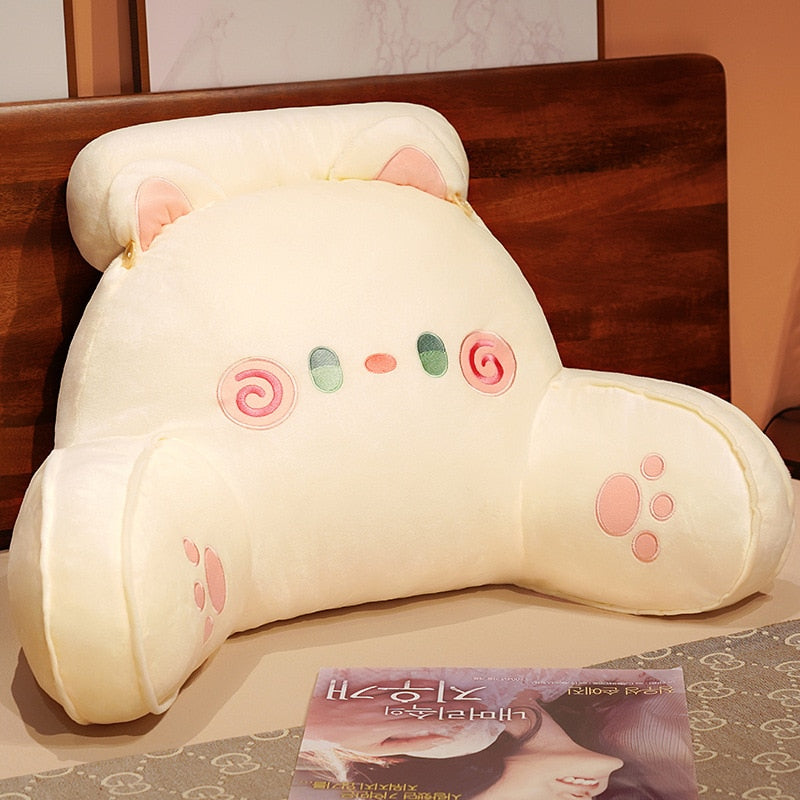 White cat reading pillow with plush rounded hood, spiral swirl eyes and paw print