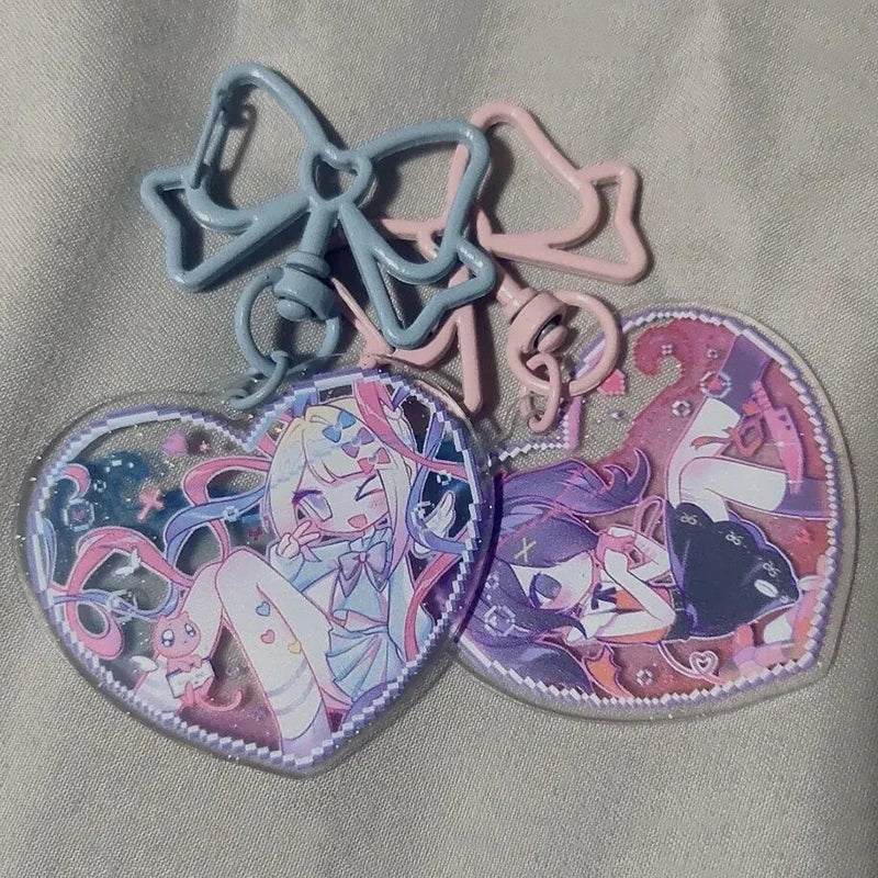 Acrylic heart keychains with blue and pink bows and character heart pendants