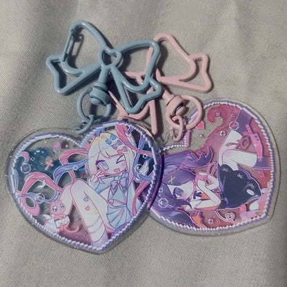 Acrylic heart keychains with blue and pink bows and character heart pendants
