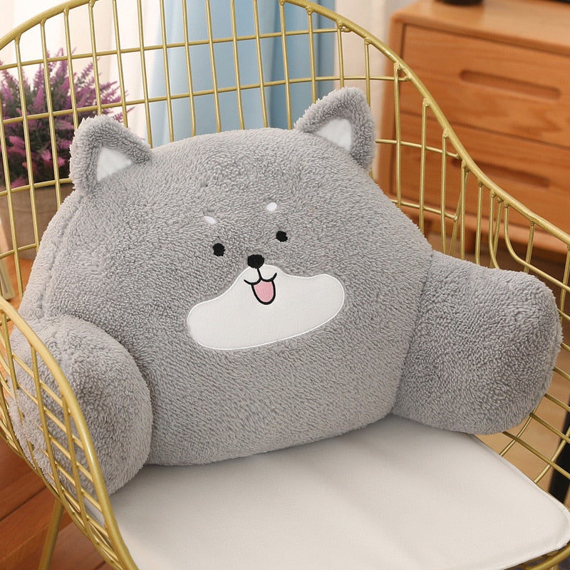 Plush gray husky cushion with white belly patch and black nose in a chair.