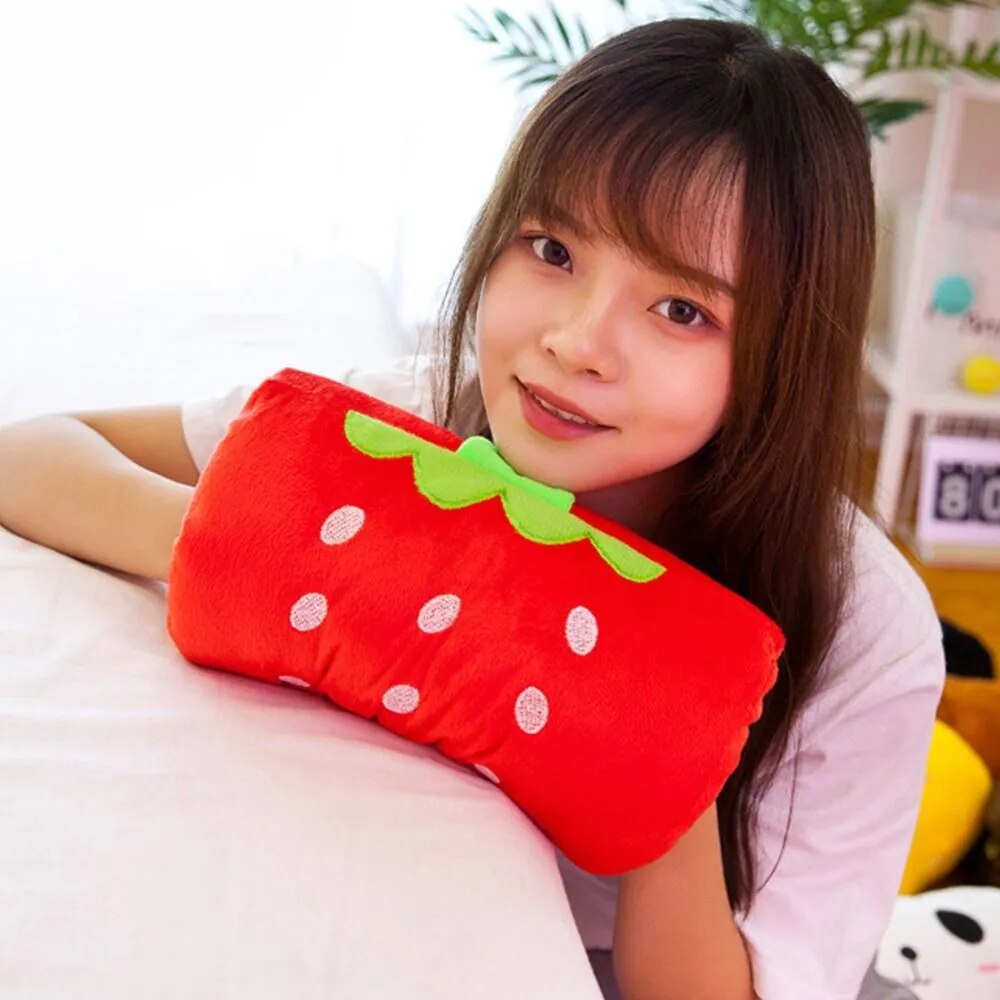 Red plush hand warmer pillow with strawberry design, green leaf and white dots