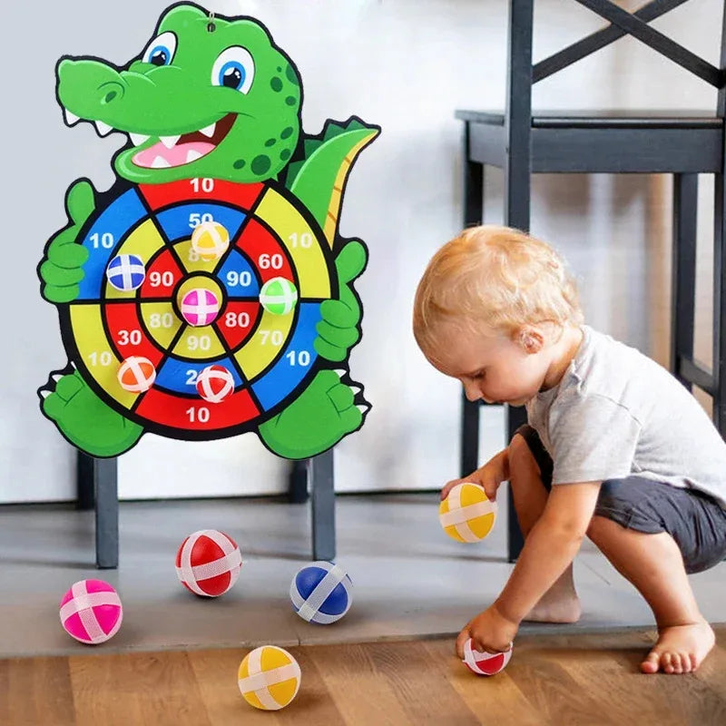 Crocodile dart board toy with numbered target rings and three striped sticky balls