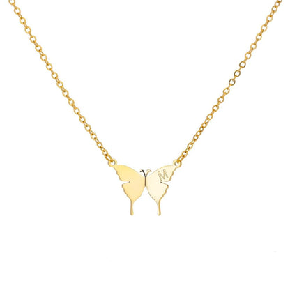 Gold butterfly initial letter necklace with M charm on a chain