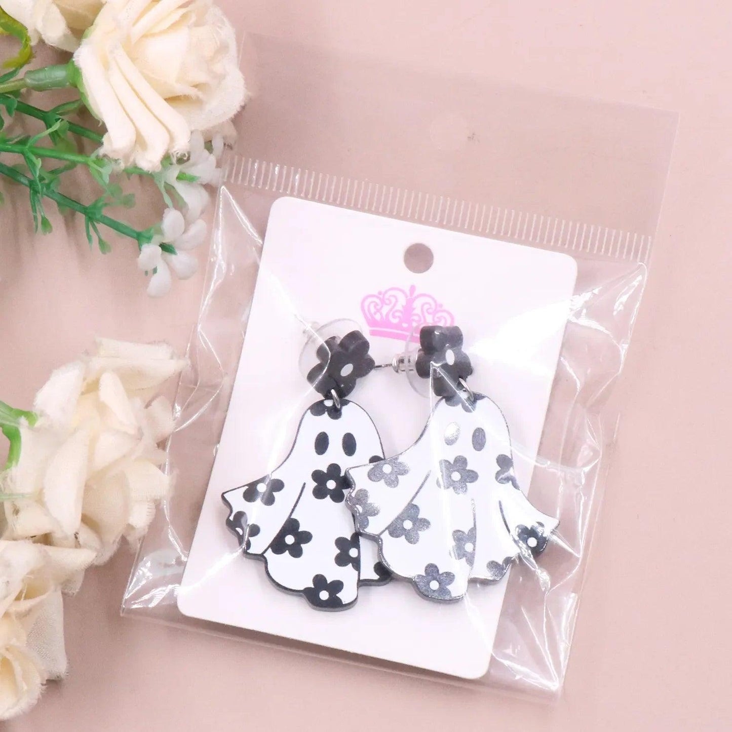 Ghost earrings in clear package, black flower tops with white floral ghost charms