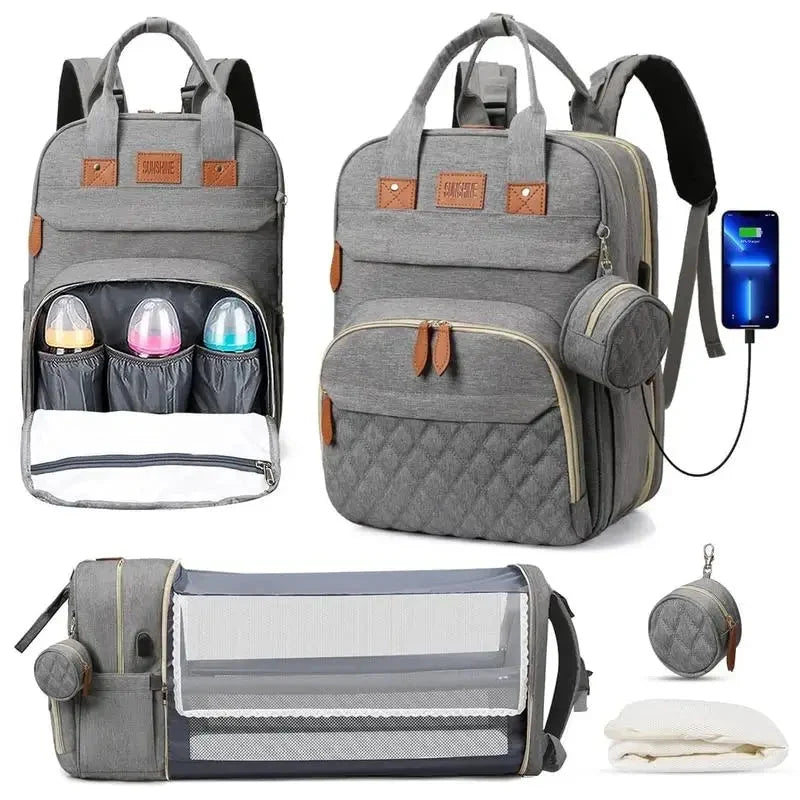 Gray diaper bag backpack with foldable baby bed, bottle pockets, and USB cable.