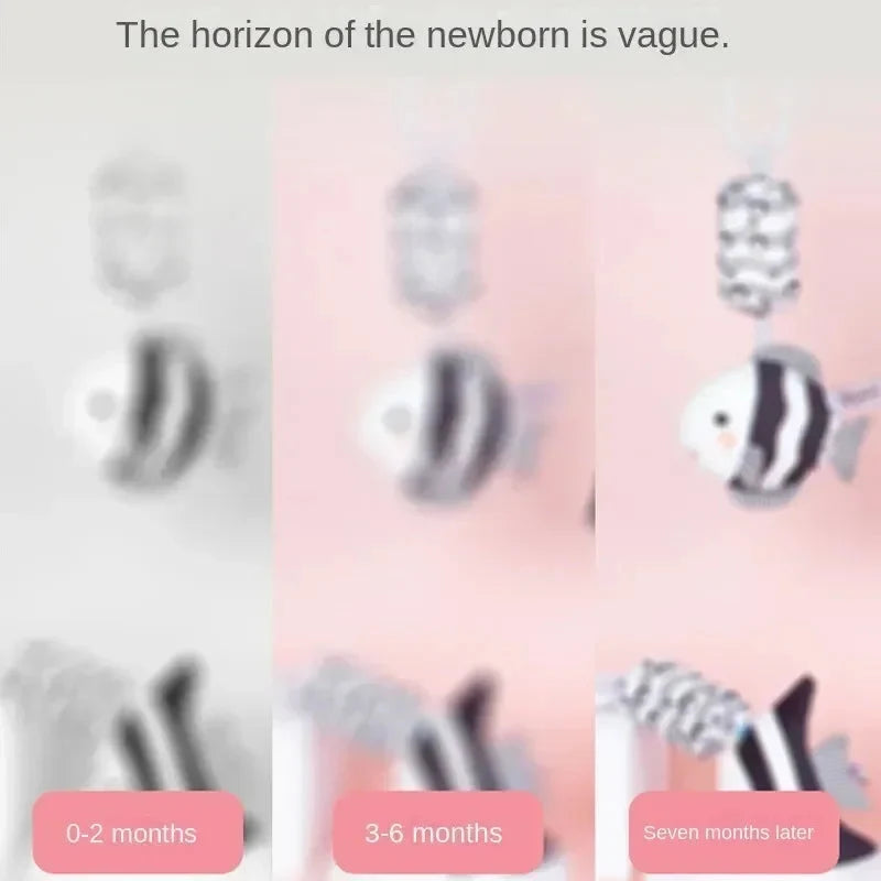 Hanging plush baby rattles with black-and-white animal designs on a size guide