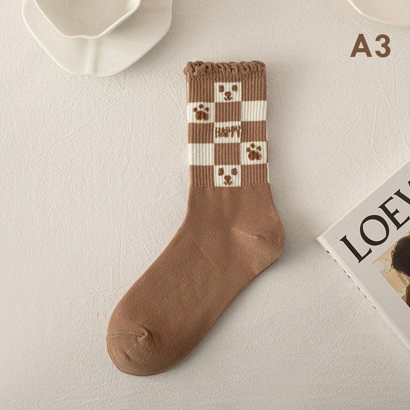 Teddy bear socks with brown legs and white checkered cuff, bear square appliques