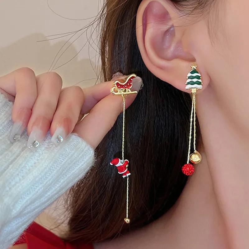 Holiday drop earrings with gold-tone hooks, Santa figure charm, and red berry dangle
