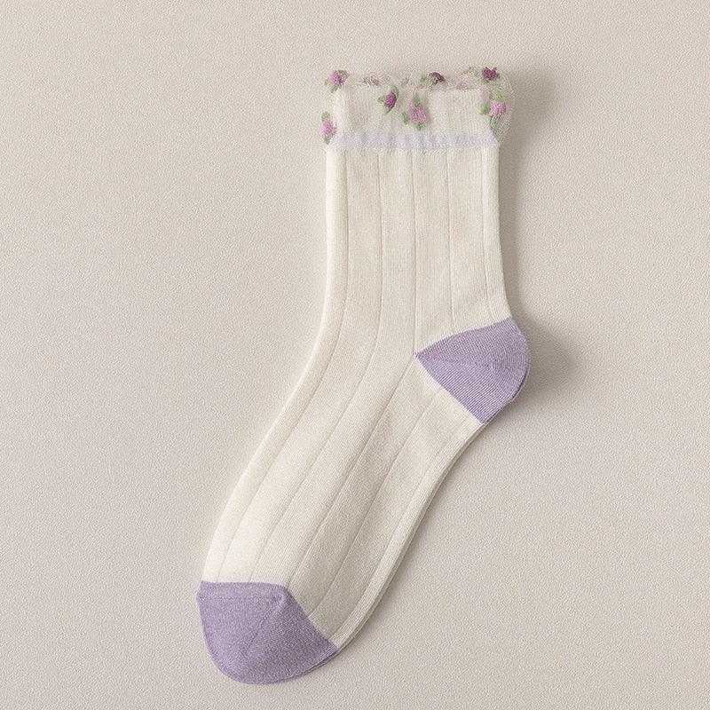 White socks with ribbed stripes, lavender cuffs, and small purple flower details
