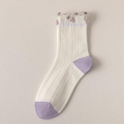 White socks with ribbed stripes, lavender cuffs, and small purple flower details