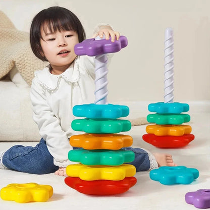 Rainbow stacking tower toy with colorful disc stack on white poles, with extra pieces