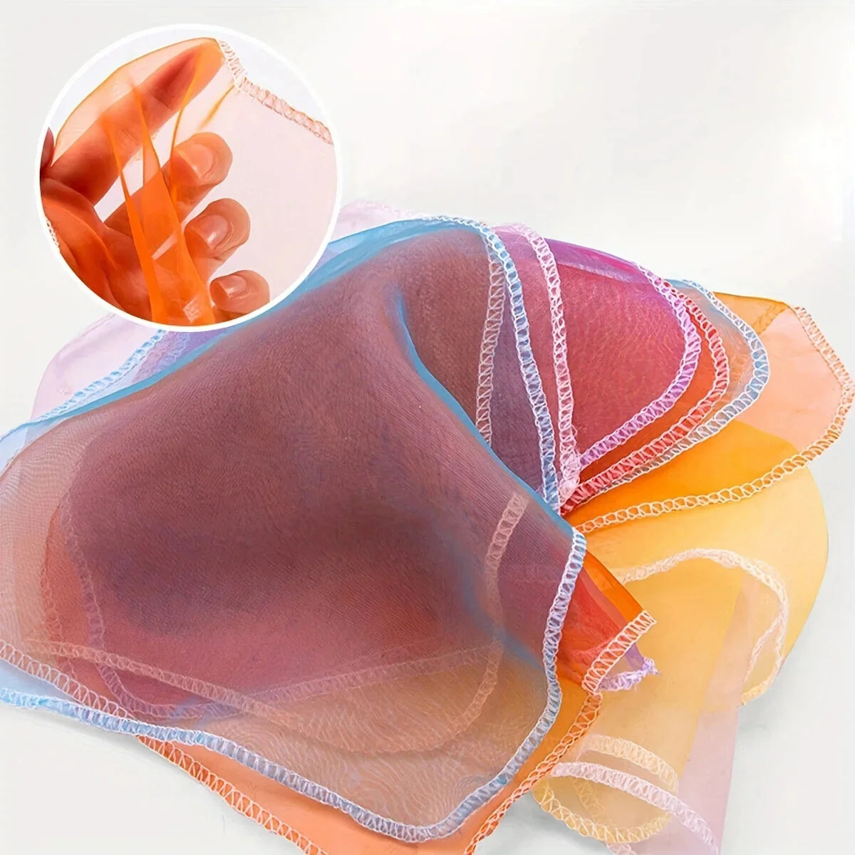 Soft fabric tissue box toy with layered ribbon-like mesh strips in pastel colors
