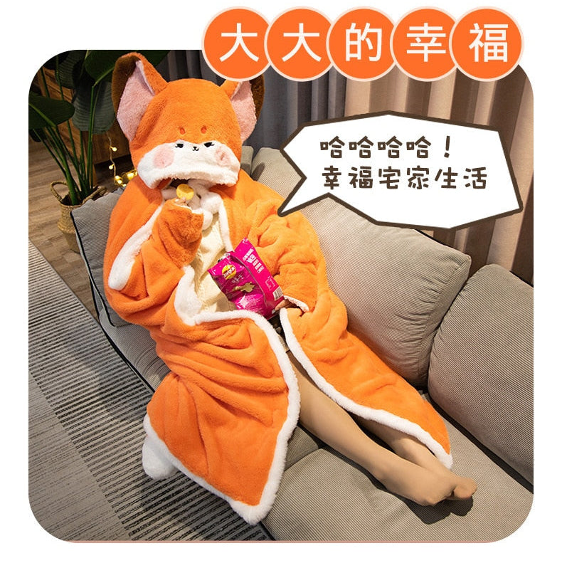 Orange fox blanket hoodie with fox-face hood and snack pouch while relaxing on couch