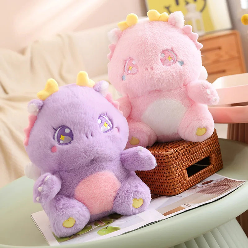 Pink and purple dragon plush toys with yellow horns and heart accents