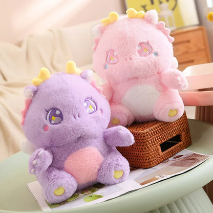 Pink and purple dragon plush toys with yellow horns and heart accents
