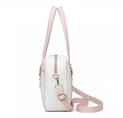 Kawaii messenger bag side view with pink-and-white design and crossbody strap with gold hardware