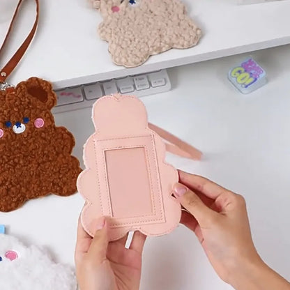 Pink plush animal photo card sleeve with clear window, held in hand