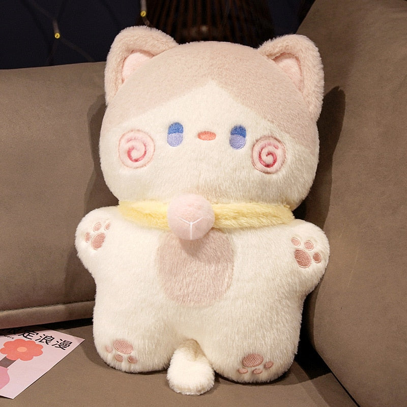 Cream cat-shaped plush pillow with blue eyes, pink swirl cheeks, and neck scarf