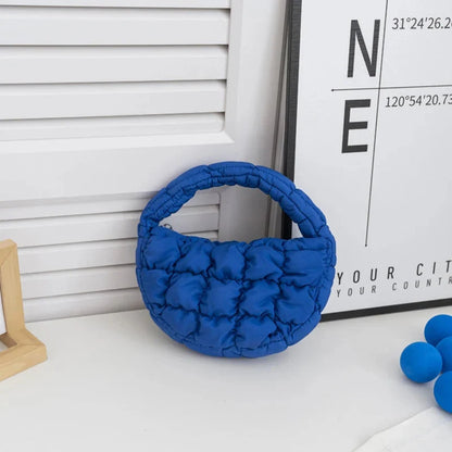 Quilted puffer circle mini bag with top handle, royal blue padded nylon.
