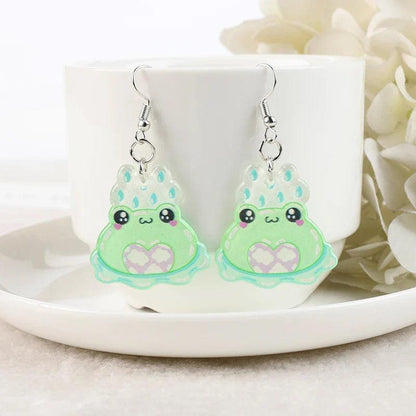 Frog acrylic earrings with light green frog charms, teal drops accents, and silver hooks