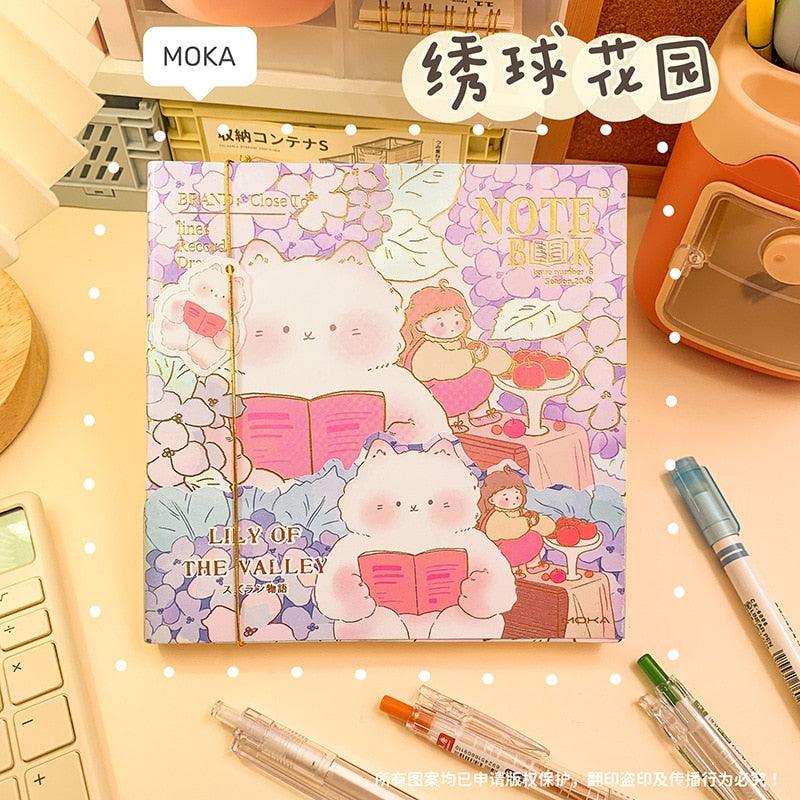 Lavender illustrated notebook cover with rabbits, flowers, and 'NOTE BOOK' title