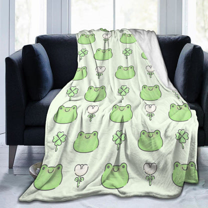 Flannel frog blanket in pale green and off-white with green frog and clover icons