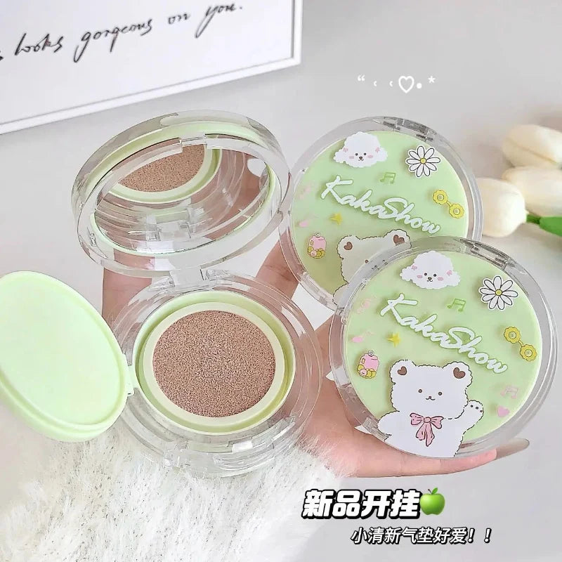 Air cushion foundation compacts in clear cases with green cushion inserts and bear flower graphics