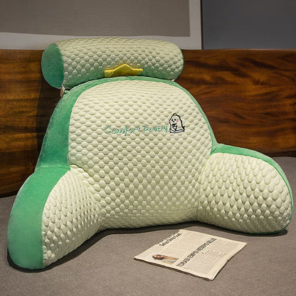 Green and cream plush reading pillow with padded front and character patch