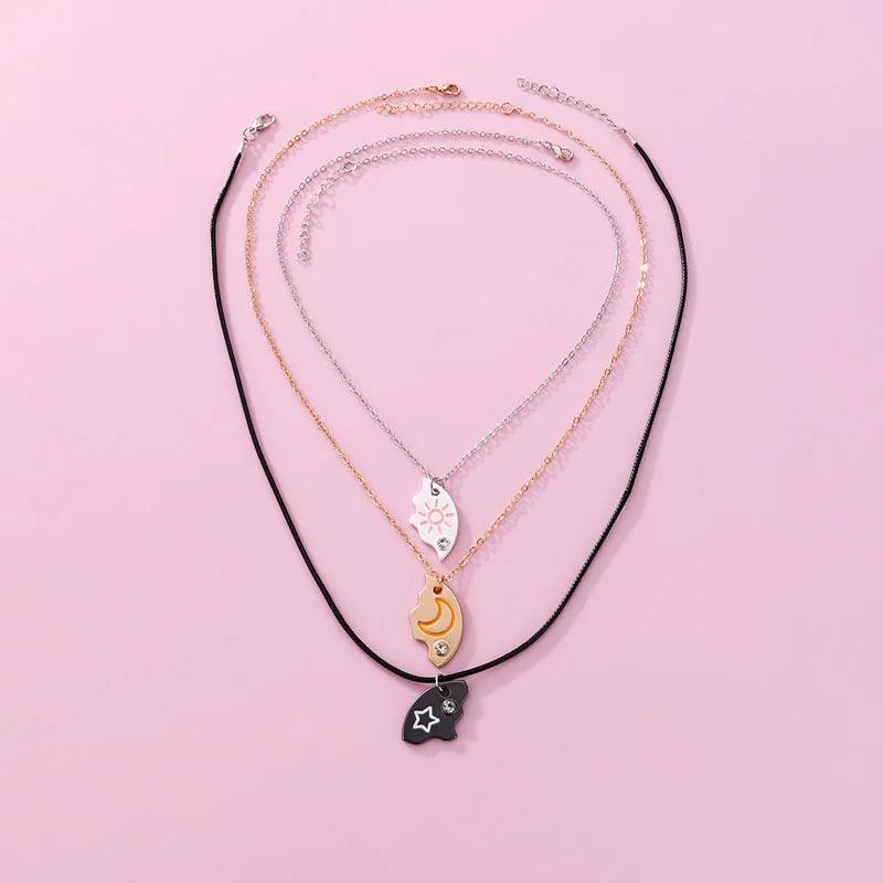 Friendship necklace set with black cord and gold and silver chains featuring moon-sun pendants