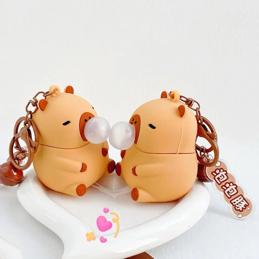 Capybara squeeze toy keychain pair view, brown plush faces with two bubble domes