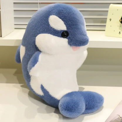 Blue dolphin plush with white belly and fin, embroidered eye and smiling muzzle